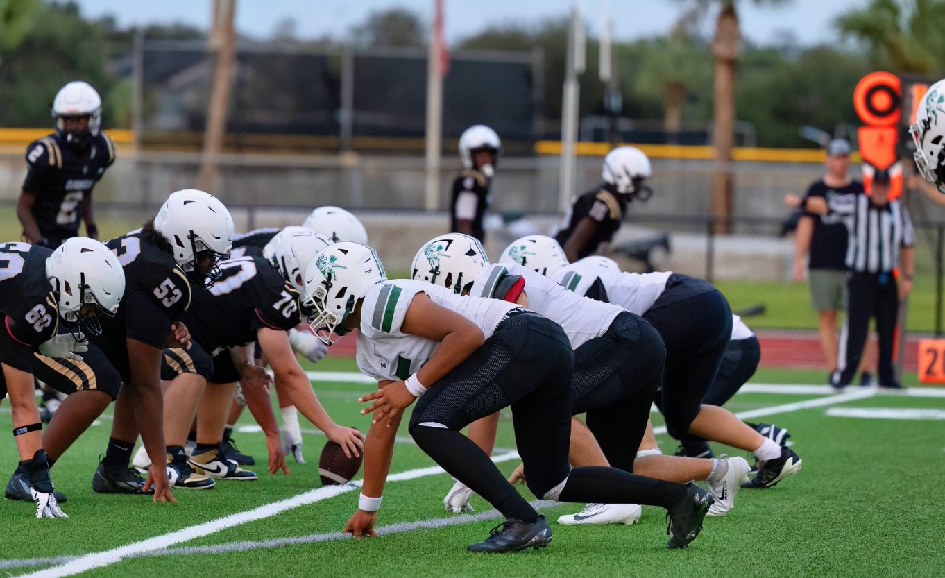Football teams lined up at the line of scrimmage before the snap